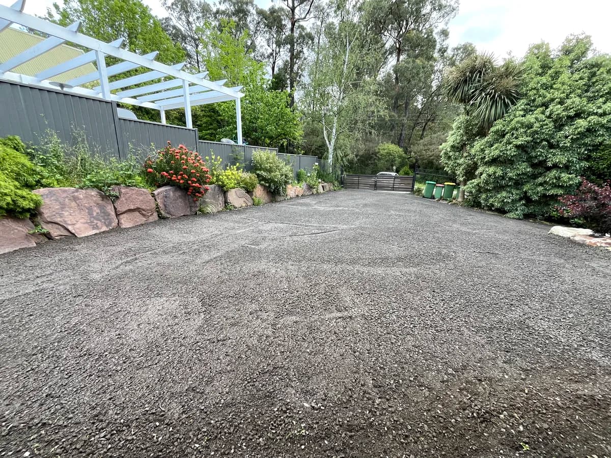 Completed crushed rock driveway with rock borders and native gardens