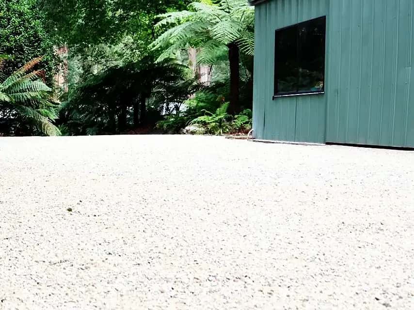 Same yard finished with fresh compacted crushed rock pad and basalt feature stones